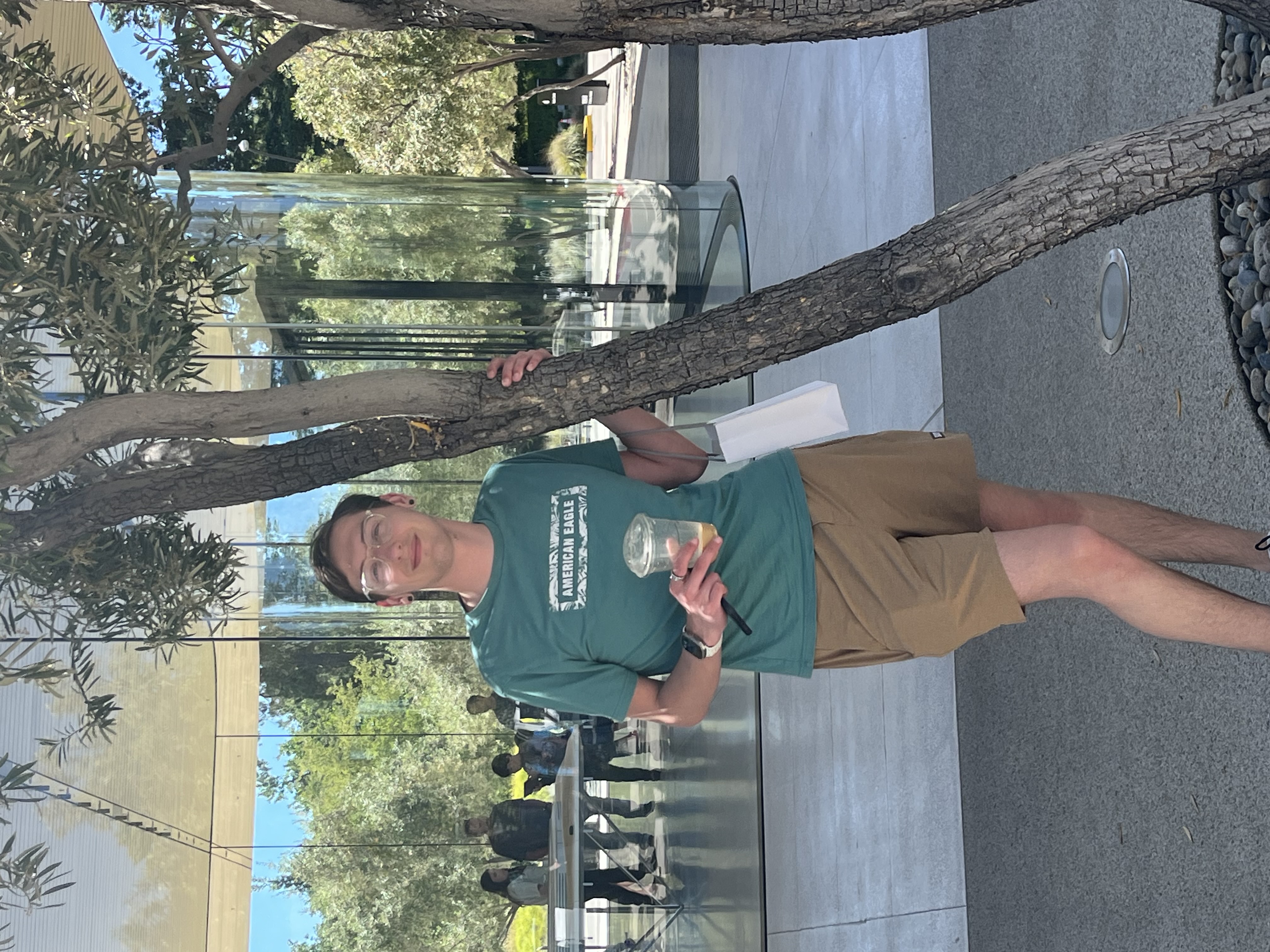 a man leaning against a tree